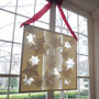 2011 White House Christmas East Colonnade- 4' Paper frames of hand cut poinsettias designed & hand assembled by Jami Darwin
